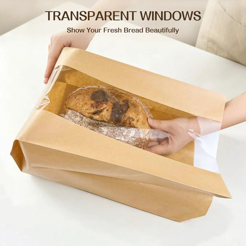 Hands placing bread into 100 Pack Bread Bags With Clear Window And 120 Stickers For Homemade Bread Storage Sourdough Bread Bags For Bread Cookies And Snacks In Large Bakery Paper Bags