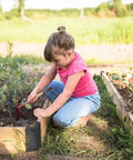 Child gardening with corner brackets for raised garden beds, securing lip visible on 2x12 lumber, set of 4, black steel.