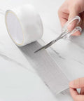 Window Screen Repair Patch Tape No Fuss Self Adhesive Mesh Patch With Double Sided Adhesive being cut for easy home repair