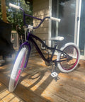 Purple BMX bike with white tires featuring a swallow shaped high carbon BMX handlebar 585mm long with 22.2mm clamp for small kid bikes.