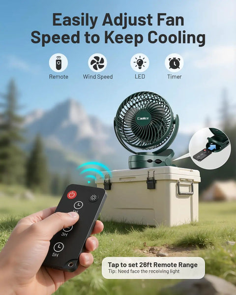 Camping Fan With Remote Control And 12000mAh Battery LED Light Hanging Hook Rechargeable Battery Operated Tent RV Fan For Bed Or Camp Three Quiet Speed Settings Portable Battery Powered Ceiling Style Fan Green in outdoor setup with remote shown in hand.