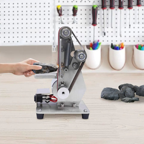 Rock Solid Mini Belt Sander With Seven Adjustable Speeds For Smooth Wood Finishing And Polishing Hella Durable Stainless Steel Bench Grinder Buffing Rig For Weekend Warrior Workshops, compact sander with rocks being polished.