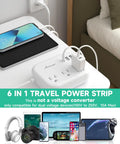 Grab And Go Global Travel Power Strip With Universal Plug Adapter, 3 outlets, USB ports charging devices on a table.