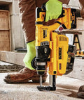 High Octane 20v Max Rotary Hammer Kit with rigid D handle drilling into concrete surface on a construction site.