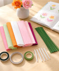 Crepe Paper Flower Kit With Floral Stem Wire And Tape Set For DIY Paper Flowers, Bouquet Craft Supplies, Durable Materials For Wedding, Party And Home Decor., crepe paper sheets, stem wire, tape, and glue sticks on table