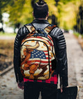 Person wearing Farmland Patriotic Bull Print Unisex Backpack Large Capacity Durable Polyester Daypack with flag design outdoors.