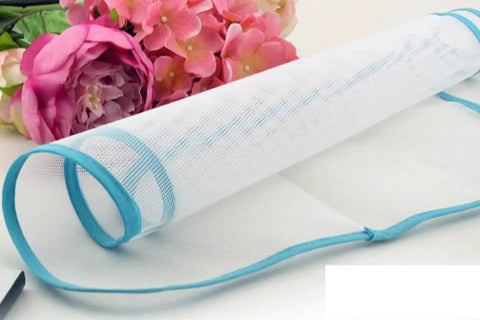 Protective Ironing Pad For Steam Irons 23 By 15 Inches Two Pack Durable Washable Polyester Mesh Shield Keeps Clothes From Scorching And Shine While Protecting Iron Surface From Zippers And Snaps next to pink flowers
