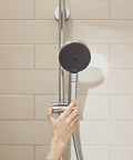 Pulsify S 24 Inch Wall Bar Shower System With 3 Jet Types PowderRain, 2.5 GPM Handheld Shower Head, in chrome, being adjusted by hand.