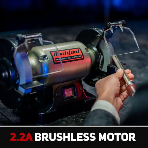 Heavy Duty 6 Inch Low Speed Bench Grinder Featuring Rock Solid Wobble Free Dual Grit Aluminum Oxide Wheels Built Garage Ready For Metal Wood And Workshop Jobs Killing Dust And Rust With Ease And Zero Skip Anytime You Hit Switch, close-up of motor and hand adjusting metal.