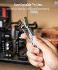 Hand holding Compact Seven Tool Folding Set With Screwdrivers And Hex Keys For Photographers On The Go in a workshop.