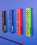 Four color-coded magnetic hex bit holders mounted on a blue metal surface, part of the 36 Piece Magnetic Hex Bit Holder Set 4 Pack.