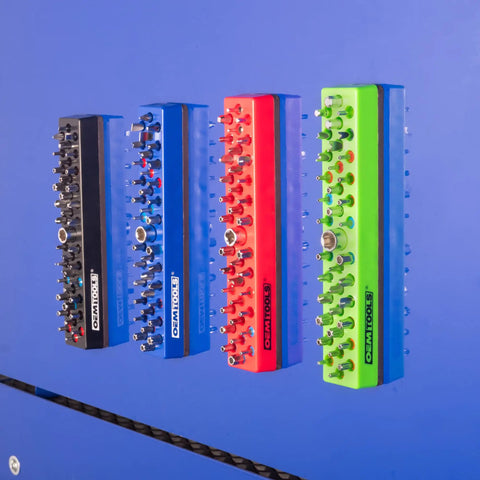 Four color-coded magnetic hex bit holders mounted on a blue metal surface, part of the 36 Piece Magnetic Hex Bit Holder Set 4 Pack.