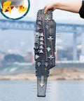 Person holding Dual-Motor 30 Km/H RC Battleship With Waterproof Hull And Sealed Cabin, showcasing detailed top view.