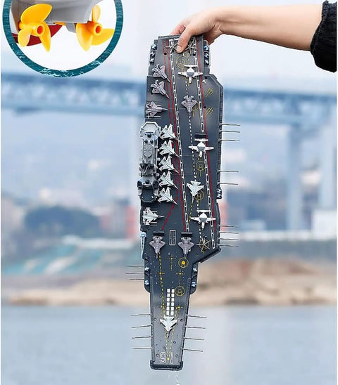 Person holding Dual-Motor 30 Km/H RC Battleship With Waterproof Hull And Sealed Cabin, showcasing detailed top view.
