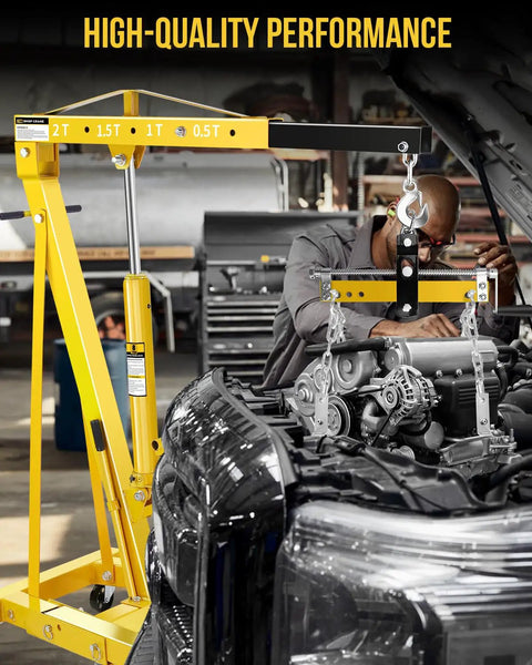 Heavy Duty Bad Boy Hydraulic Shop Crane Doubles As An Engine Hoist With Six Rolling Casters in use lifting a car engine.