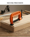 Heavy Duty Iron G Clamp With Massive 3 Inch Jaw holding two wood pieces together on a workbench during assembly.