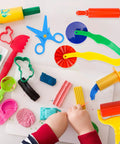 Child playing with 9-Piece Dough And Clay Tools Starter Set For Kids With Rollers, Pizza Cutter, Rolling Pins, Safety Scissors
