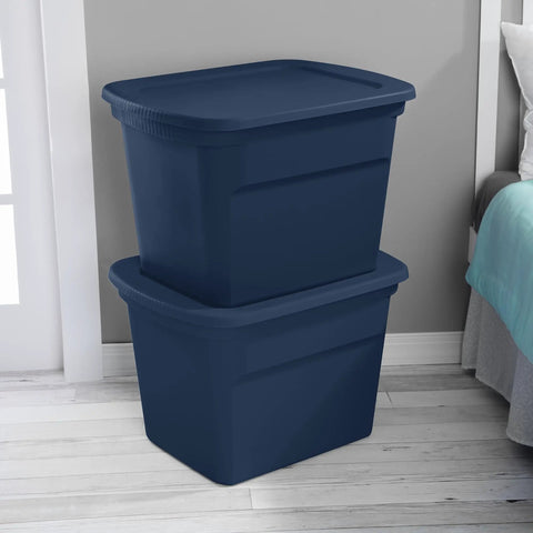 No Sweat 18 Gallon Plastic Storage Totes With Secure Snap Lids 32 Pack stacked navy bins in a bedroom for organizing clothes.