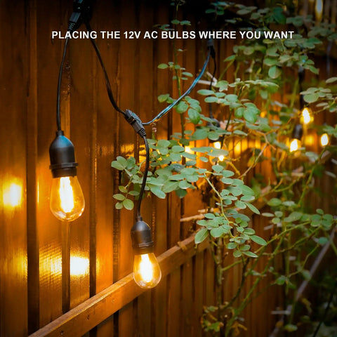 Warm White 50ft Low Voltage String Lights With 10 2W Bulbs, 135 Lumens Each, 2800K, Weatherproof on wooden fence near foliage