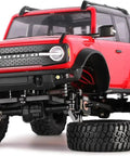 RC crawler with beefy brass caster blocks C hubs and steering knuckle kit for TRX4M 1/18 upgrades, red body, black coat