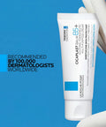 Ultimate Go To Healing Balm With Vitamin B5 Soothing Cream For Dry And Irritated Skin in white tube on blue background.