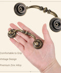 Hand holding Antique Bronze Drop Bail Drawer Pulls Set Of 10 With 4.5 Inch Total Length And 3.5 Inch Center, Vintage Cabinet Handles