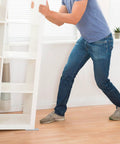 Person using Furniture Sliders For Carpet, Hardwood And Tile Floors, 16 Pack 1 Inch By 4 Inch Rectangular Self Adhesive Pads.