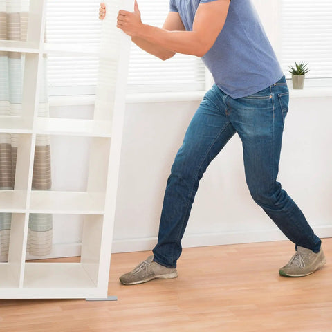 Person using Furniture Sliders For Carpet, Hardwood And Tile Floors, 16 Pack 1 Inch By 4 Inch Rectangular Self Adhesive Pads.