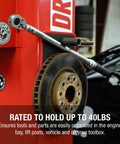 Flexible Magnetic Mat And Organizer For Tools 8 By 10 Inches holds a wrench and car rotor on a garage lift.