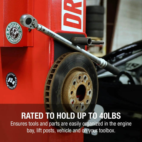 Flexible Magnetic Mat And Organizer For Tools 8 By 10 Inches holds a wrench and car rotor on a garage lift.
