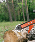 Knockout Chainsaw Mill Attachment And Log Debarker Peeler featuring four heavy duty blades on log in forest setting.