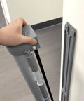 Hand demonstrating one-hand operation of the Retractable Baby And Pet Safety Gate 54 Inch Wide 34 Inch Tall for doorways.