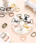 Slick D Rings Kit With Swivel Clasps Slide Buckles And Lobster Hooks For Handbags Lanyards Dog Gear And Craft Sewing Ninety Six Piece Set showing various hooks and rings on a pale background.