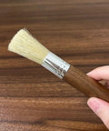 Grinder Cleaning Brush Set With Walnut Wood Handle And Natural Bristles For Espresso Machines And Home Baristas shown in hand