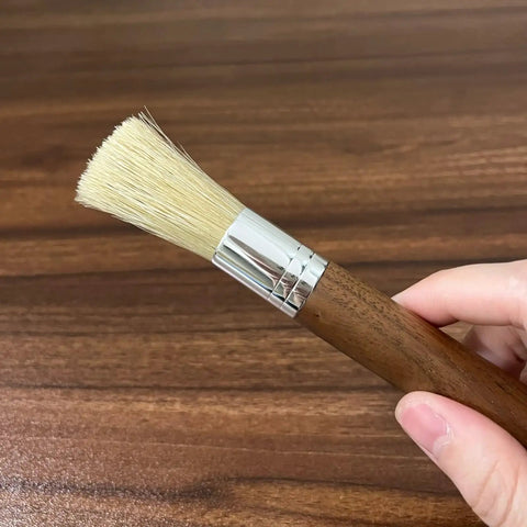 Grinder Cleaning Brush Set With Walnut Wood Handle And Natural Bristles For Espresso Machines And Home Baristas shown in hand