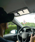 Driver using 12 Pack Car Visor Clips For Sunglasses Holder And More Multipurpose Vehicle Visor Accessories in black on sun visor.