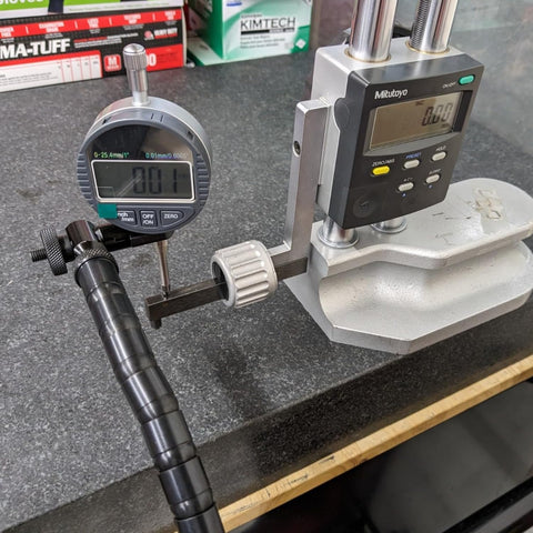 DXphita disc brake rotor runout gauge set with 1'' digital indicator and Mitutoyo readout mounted on a locking vise.