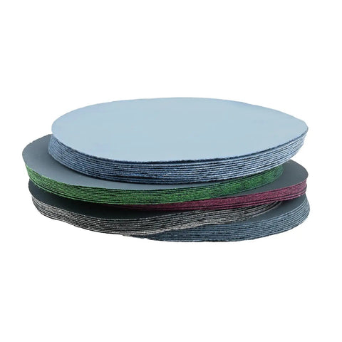 50 Pack Premium Round Wet Dry Sanding Discs Grit 1000 To 5000 for polishing stacked in a neat arrangement for various surfaces.