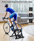 Cyclist using Indoor Bike Trainer Stand With Magnetic Flywheel For 26 To 28 Inch Road And Mountain Bikes in living room.