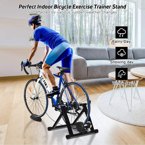 Cyclist using Indoor Bike Trainer Stand With Magnetic Flywheel For 26 To 28 Inch Road And Mountain Bikes in living room.