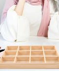 Knockout Solid Wood Jewelry Tray With 12 Grid Compartments, smooth polished finish on a chic vanity table.