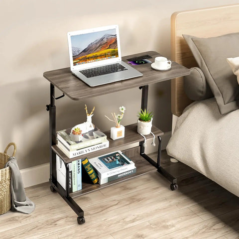 Unwind And Handle Daily Grind At This Grey Oak Rolling Standing Desk With Height Adjustable Top Smooth Gliding Wheels Grab And Go Mobility Side Hooks And Roomy Storage Shelves For Your Home Office Setup, featuring a laptop on a spacious top.