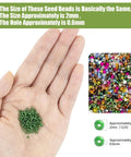 Hand holding green beads with a display of mixed colors, Huge 24000Pcs Glass Seed Beads Kit, 2Mm Beads in 28 Colors for Jewelry Making