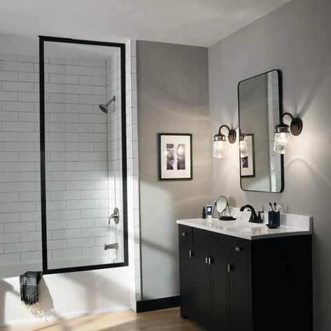 Architectural Bronze 1 Light Wall Sconce With Clear Seeded Glass next to bathroom mirror, indoor outdoor weatherproof lighting.