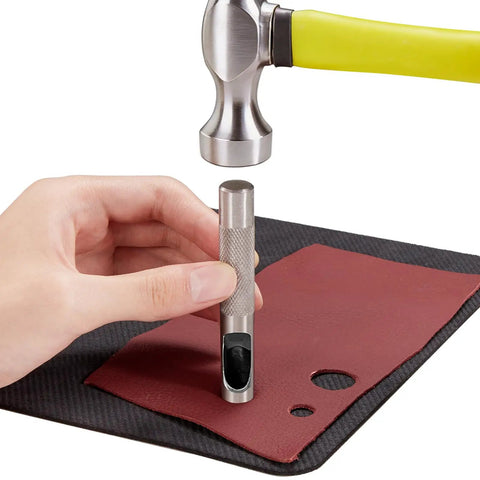 Using 12 Piece Hollow Leather Punch Set Made Of Steel on leather material with a hammer for precise crafting.