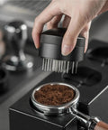 Top Tier Wdt Tool For Espresso Buffs Cuts Ground Clumps Dead Flat And Levels Your Coffee Bed For Creamy Shots Designed For 53 And 58 Millimeter Portafilter Cups Handles Daily Grind Smoothly, stirring coffee grounds.