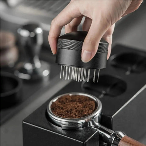 Top Tier Wdt Tool For Espresso Buffs Cuts Ground Clumps Dead Flat And Levels Your Coffee Bed For Creamy Shots Designed For 53 And 58 Millimeter Portafilter Cups Handles Daily Grind Smoothly, stirring coffee grounds.