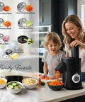 7-in-1 Electric Vegetable Chopper And Mincer With 7 Stainless Steel Blades For Fast Slicing Dicing And Shredding Of Potatoes Onions Carrots And Cheese, in use by a woman and child.
