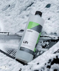 Lift Pre Wash Snow Foam Car Wash Soap That Dissolves Dirt And Grime Like A Boss For A Quick Touchless Clean bottle on soapy surface