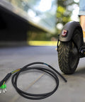 Kugoo Pro Electric Scooter Motor Cable With 5 Wire Hall Sensor Connector next to scooter wheel, 90cm PVC harness